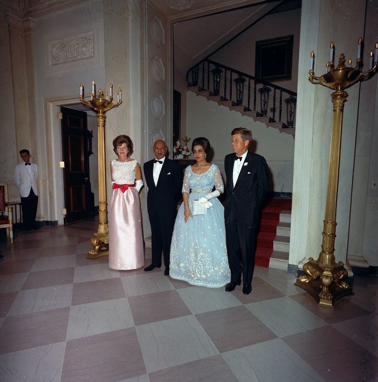 King Mohammed Zahir Shah of Afghanistan, Queen Humaria Begum, and President Kennedy are standing close to each other