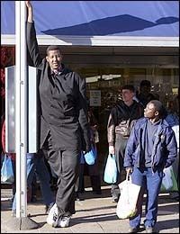 Hussain Bisad leaning on a pole while wearing a black long sleeves and black pants