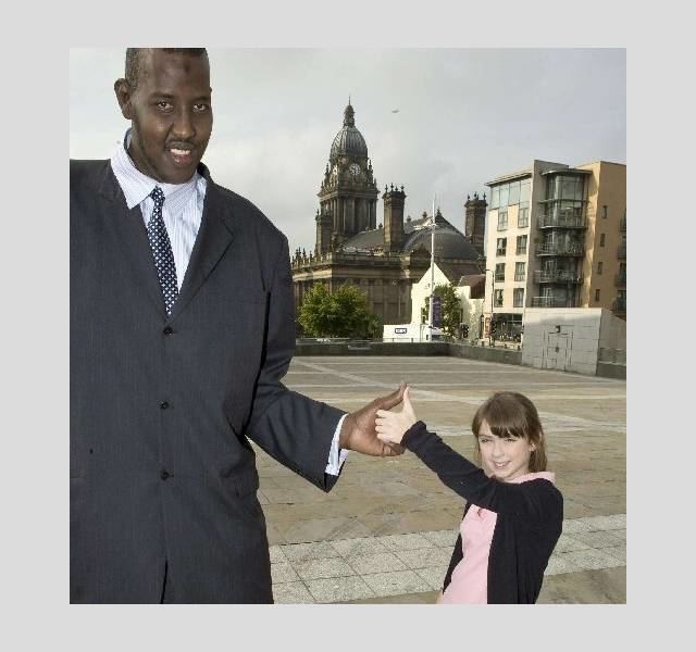 Hussain Bisad and Aimee Goodman smiling while on a thumb wrestling match to promote Cadbury's spots against Stripes