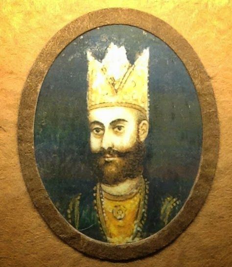 A portrait of Ibrahim Lodi with a thick beard and wearing a golden crown and green and yellow royal garbs.