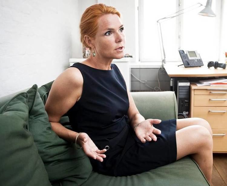 Inger Støjberg sitting down while being interviewed wearing a black, sleeveless dress.