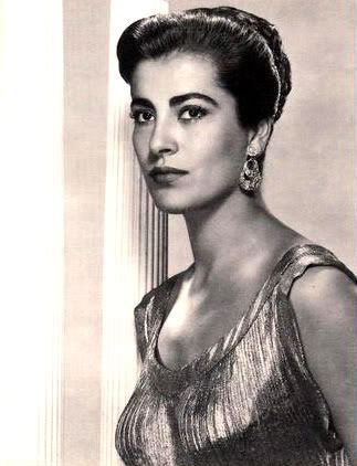 Irene Papas looking fierce while looking at the side and wearing a glossy dress and dangling earrings