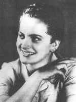 Irma Grese smiling with her hair arranged and wearing a white blouse.