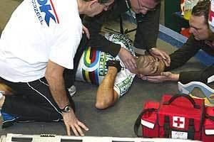 Isaac Gálvez lying on the ground while the medical staff are checking on him