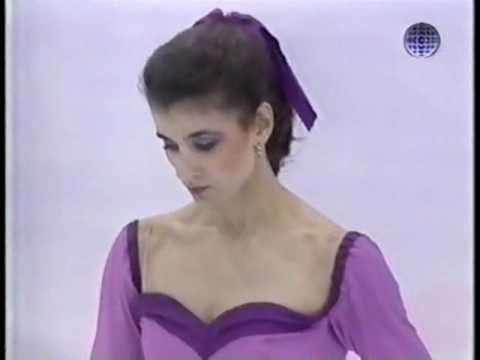Isabelle Duchesnay looking down, with a purple ribbon tied on her hair, and wearing a purple dress