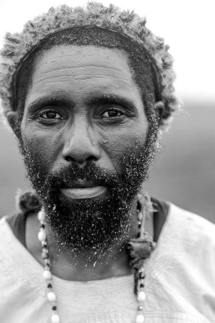 Isaiah Shembe with mustache and beard while wearing necklace and dress