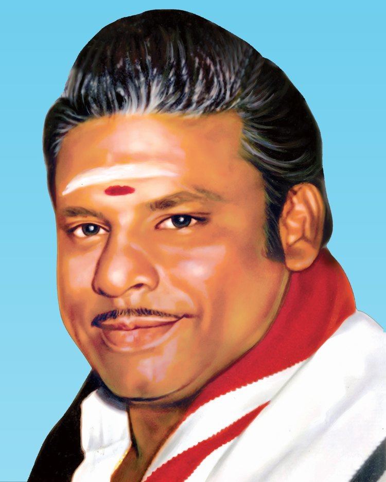 Isari Velan wearing a red and white shirt