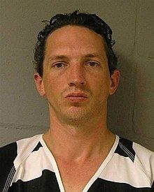 Israel Keyes wearing a black and white striped shirt