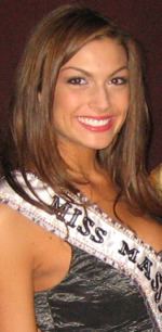 Jackie Bruno smiling while wearing a black sleeveless blouse and a sash for Miss Massachusetts