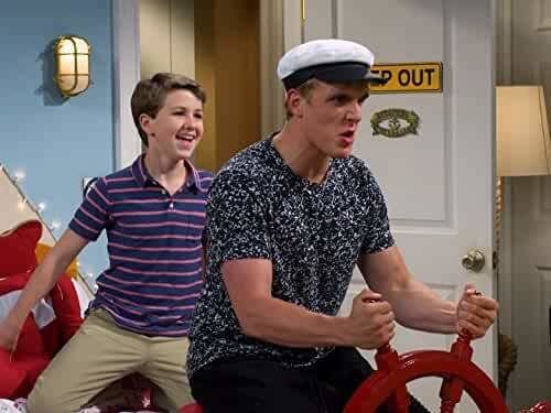 Ethan Wacker and Jake Paul holding the boat steering wheel in a scene from the 2016 comedy television series, Bizaardvark
