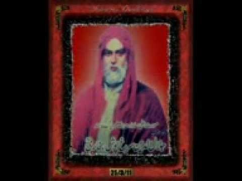 On a black background, there is a red frame with a man named Jalaluddin Surkh Posh Bukhari inside. Jalaluddin Surkh Posh Bukhari is serious, has white beard wearing a red-pinkish long cloak along with a white Thobe.