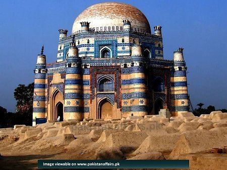 Tomb of Bibi Jawindi in Uch Sharif is a historic city in the southern part of Pakistan's Punjab province. On a desert, Bibi Jawindi's tomb, built of glazed bricks on an octagonal base with turrets on each corner and a round roof, decorated with Islamic scriptures, carved timber, and bright blue and glazed white mosaic tiles. The surrounding area is covered with desert like cemented graves.