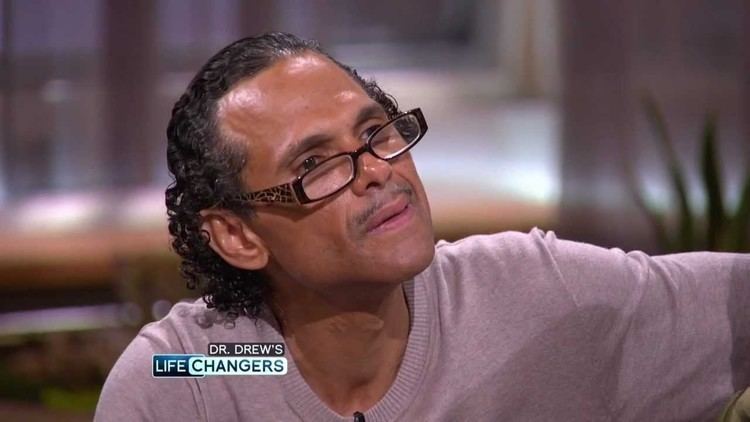 James DeBarge wearing eyeglasses and gray sweatshirt