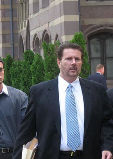 James Galante entering the US District Court in New Haven while wearing a black coat, white long sleeves, and blue necktie