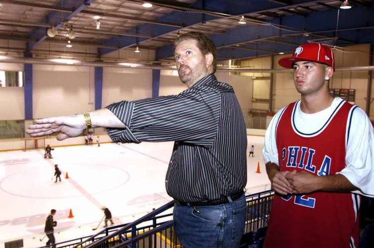 James Galante overseeing the renovations for the Danbury Ice Arena in 2004 while he is wearing black stripes long sleeves and denim pants