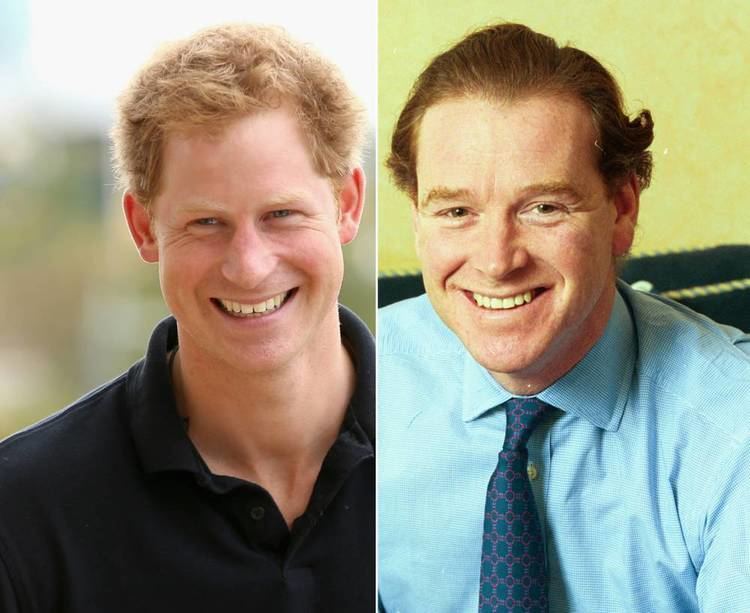 On the left, Prince Harry, Duke of Sussex is smiling, has blond hair wearing a black polo shirt, at the right, James Hewitt is smiling, in a couch in front of a yellow wall, has brown hair wearing a blue long sleeve polo with dark blue necktie.