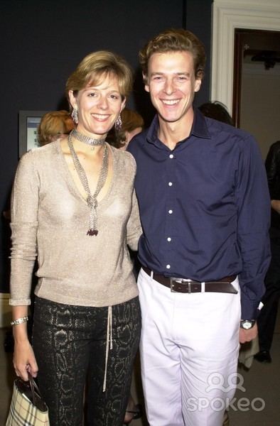 James Ogilvy smiling and wearing blue long sleeves and white pants while Julia Ogilvy wearing a beige blouse and black pants