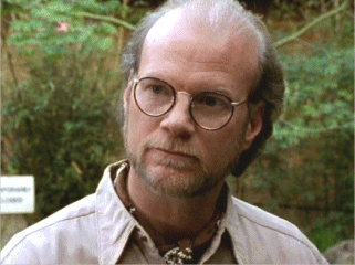 James Stephens as Doctor Weirick with facial hair and wearing a cream polo shirt and eyeglasses in a scene from Buffy the Vampire Slayer, 1997.
