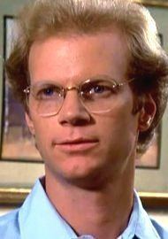 James Stephens as James T. Hart wearing eyeglasses and a sky-blue polo shirt in a scene from The Paper Chase, 1978.