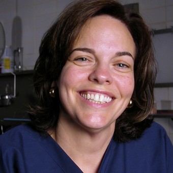 Jan Garavaglia with a smiling face and wearing a blue shirt.