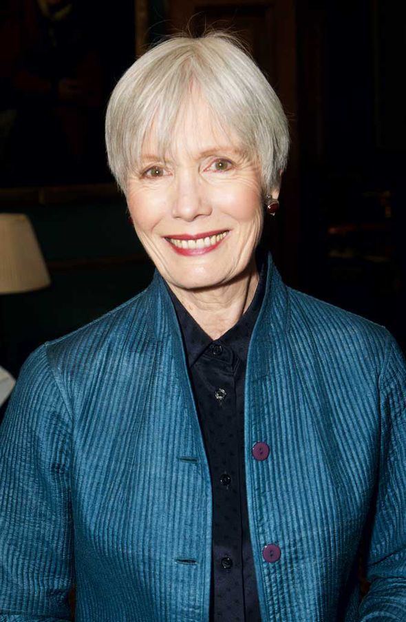 Jane Wymark smiling while wearing a blue blazer and black blouse
