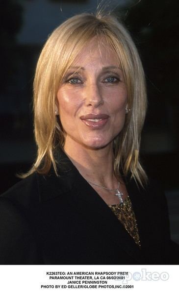 Janice Pennington smiling while wearing a black blouse, earrings, and necklace