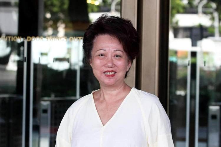 Jannie Chan Siew Lee (Hour Glass Co-founder) is smiling, has black short hair, wearing a plain white top.