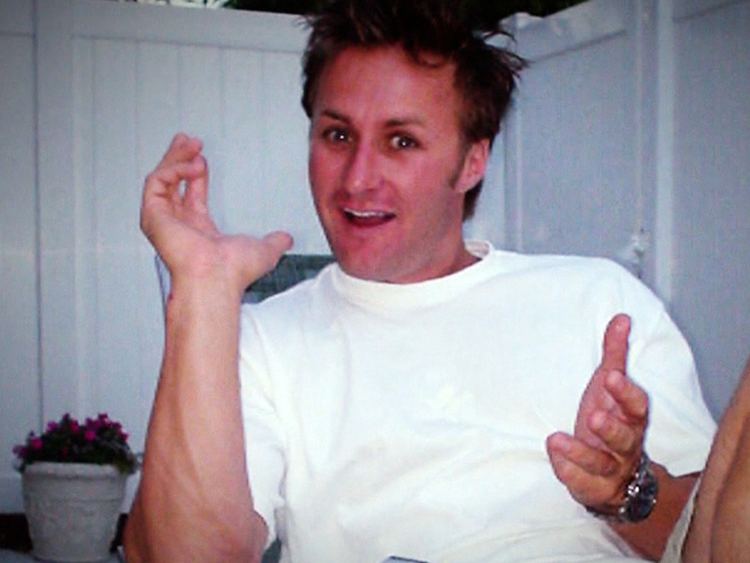 Jason Derek Brown smiles while wearing a white shirt