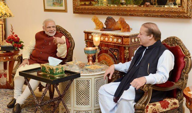 Nawaz Sharif sitting in a bench and talking to a guest inside Raiwind Palace found in Jati Umra.