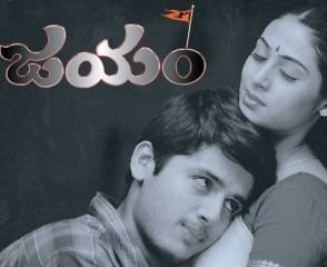 Movie poster of Jayam, a 2002 Indian Telugu-language romantic action drama film starring Nithiin embracing Sada with eyes closed. Nithiin wearing a checkered polo shirt while Sada wearing an Indian dress.