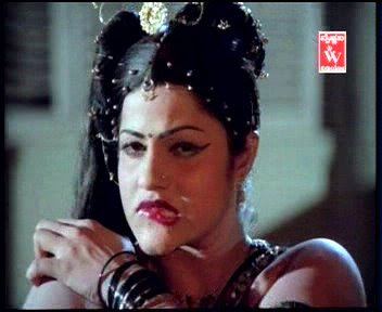 Jayamalini biting her lips, wearing many accessories, and a sexy black top in a scene from Hanthakudi Veta (1987 film).
