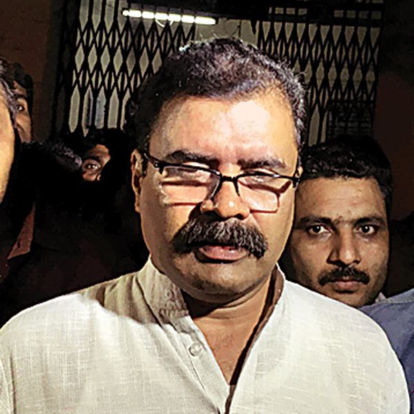 Jayendra Thakur with a mustache and wearing eyeglasses and polo shirt.