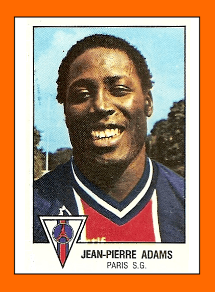 Jean-Pierre Adams with a smiling face and wearing a shirt with a white, red, and blue color combination.
