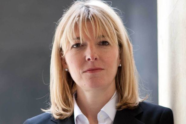 Jemma Redgrave looking serious while wearing a white shirt under a black coat and a pearl earrings