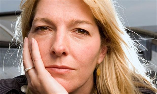 Jemma Redgrave looking serious with her hand on the cheek while wearing a ring and gold dangling earrings