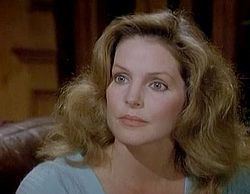 Priscilla Presley as Jenna Wade wearing a gray blouse in a scene from the 1978 tv series Dallas