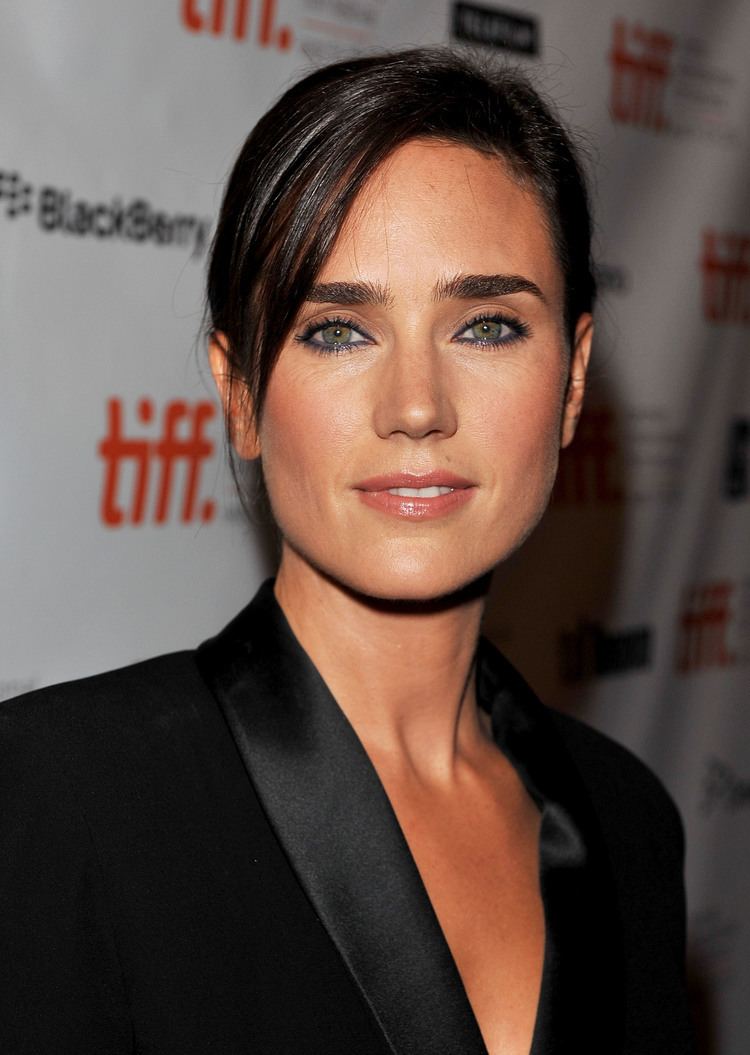in Toronto International Film Festival Jennifer Connelly is smiling, has long black hair tied up, brown eyes and mole on her left upper lips.