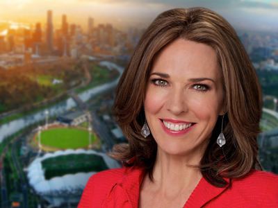 Jennifer Keyte wearing red coat and earrings