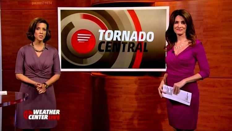 Jennifer Lopez (meteorologist) is on the Weather Channel doing weather updates with Kyla Grogan both wearing purple dresses.