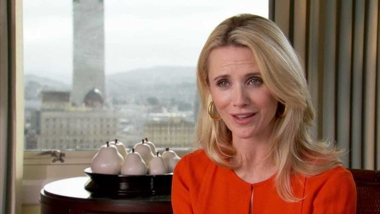 Jennifer Siebel Newsom, in one of her interviews and wearing a red dress and earrings