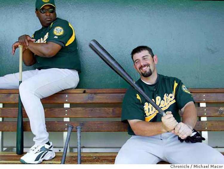 Webster Garrison a minor league coach out of Midland, Texas (the one on the left) watches Jeremy Brown gets the feel of a bat he used in practice