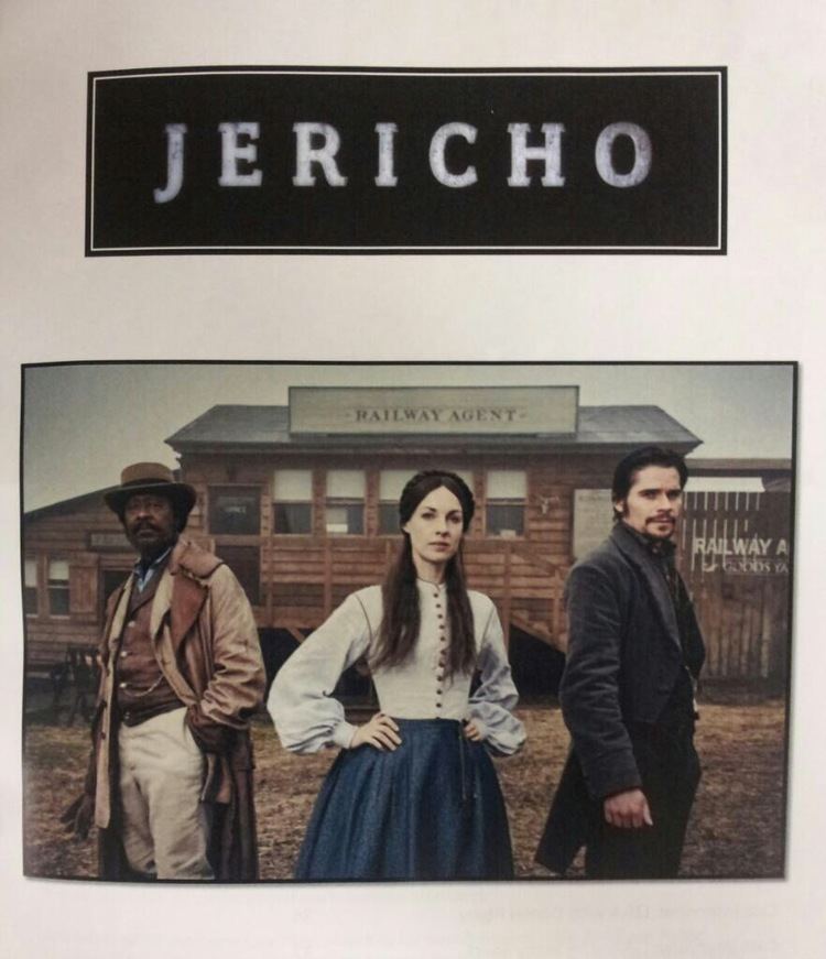 Jessica Raine posing with Clarke Peters and Hans Matheson while behind them is the building of railway agent in the 2016 period drama series Jericho