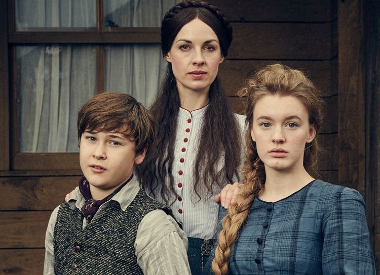 Jessica Raine wearing a white and red blouse, Sam Bottomley wearing a vest and long sleeves, and Amy James-Kelly wearing a blue checkered blouse