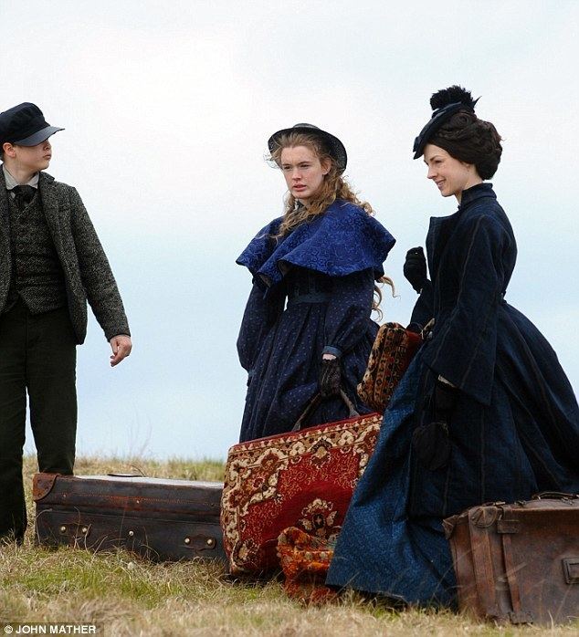 Jessica Raine, Sam Bottomley, and Amy James-Kelly carrying their suitcase in a scene from the 2016 period drama series Jericho