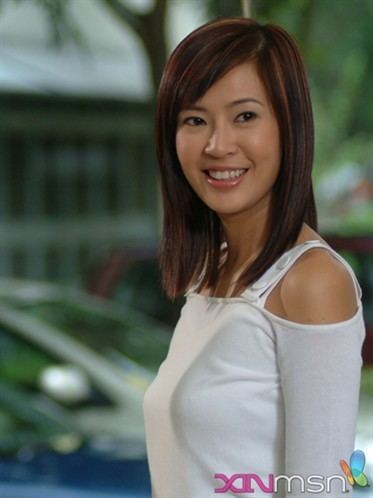 Jesseca Liu with her straight short hair wearing a white long-sleeved shirt