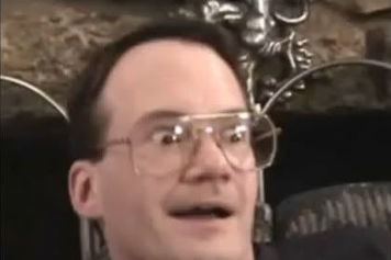 Jim Cornette wearing a surprised-looking expression and wearing eyeglasses.