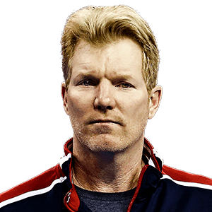 Jim Courier wearing a dark blue shirt and a jacket
