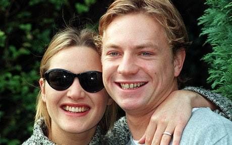 Jim Threapleton with a smiling face with his wife Kate Winslet smiling, with blonde hair and wearing sunglasses.