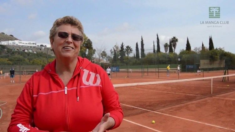 Jo Durie wearing a red jacket in the tennis court