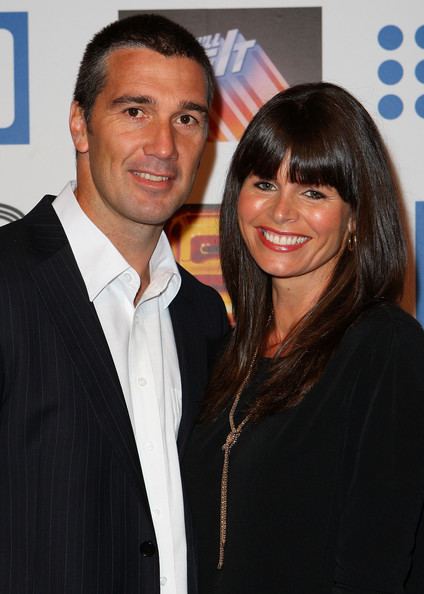 Jo Silvagni smiling with Stephen Silvagni wearing a black coat and white long sleeves